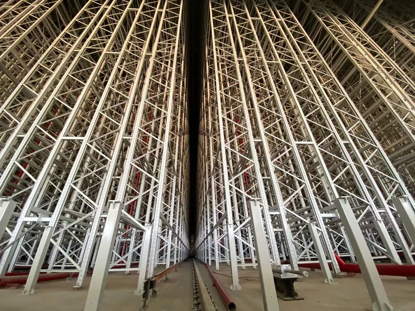 35 metre high-bay AS/RS racking towers seen from the aisle floor in a Vietnamese tyre plant