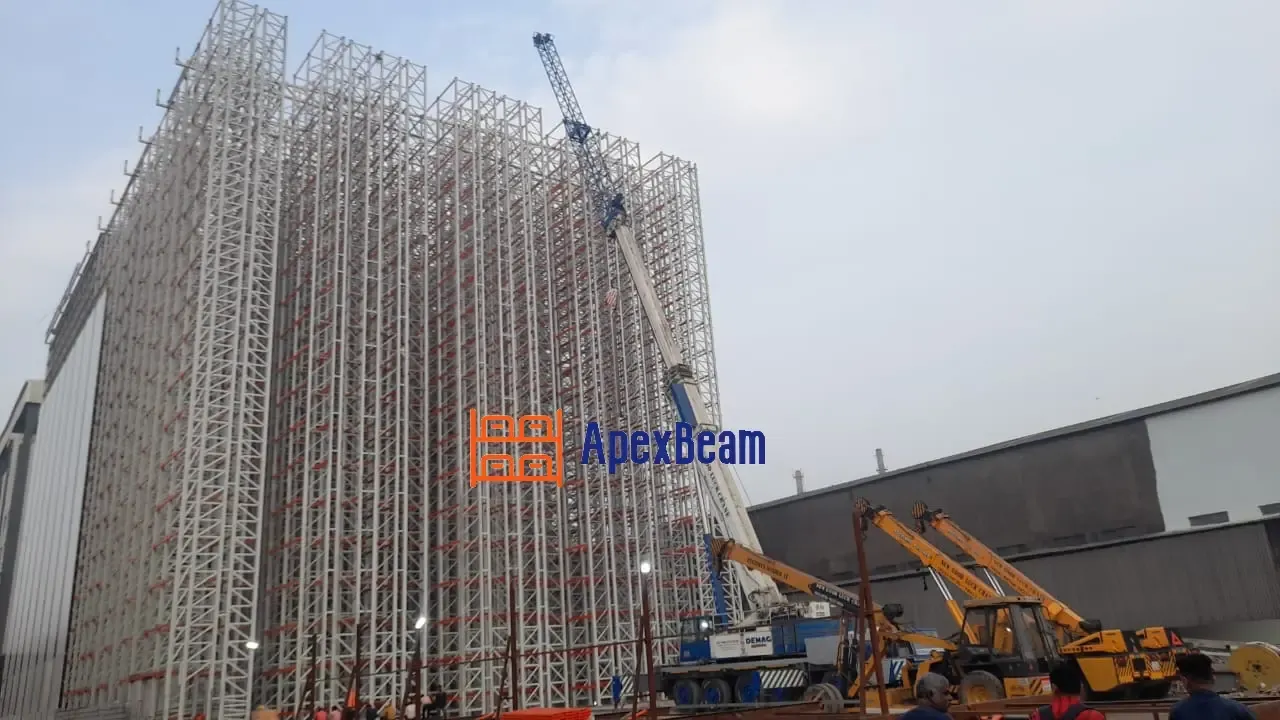 37 m rack-supported building under construction in India — the racking structure itself carries the roof and wall cladding loads (ApexBeam project)